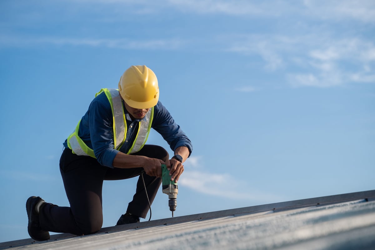 ACO Roofing crew member repairing a roof on a Dallas home